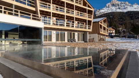 Hotel with infinity pool and snowy winter landscape