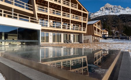 Hotel with infinity pool and snowy winter landscape