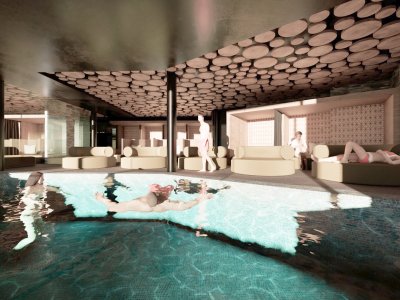Personen schwimmen im Pool, runde Sofas und Liegen im Hintergrund