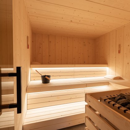 Cozy wooden sauna with infusion bucket