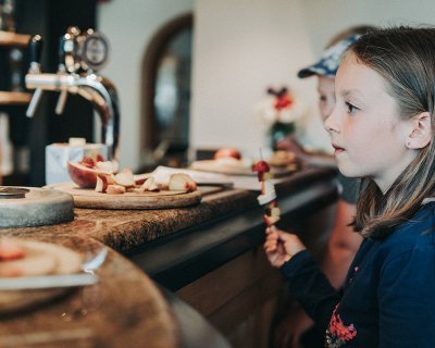 Girl with fruit skewer at the counter