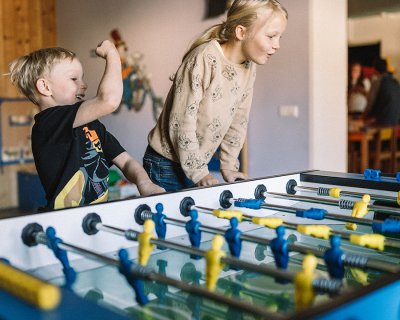 Kids playing table football with excitement
